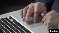 A cyber warfare expert works on his laptop computer in Charlotte, North Carolina, December 1, 2011.