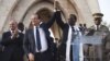 France's President Francois Hollande (2nd L) joins hands with Mali's interim president Dioncounda Traore at Independence Plaza in Bamako, Mali February 2, 2013.