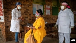 A South African woman is briefed before taking a COVID-19 test in Groblersdal , north-east of Johannesburg, Feb. 11, 2021 as African countries without the coronavirus variant dominant in South Africa are asked to go ahead and use the AstraZeneca COVID-19