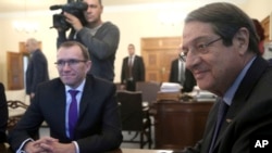 U.N. Special Advisor of the Secretary-General Espen Barth Eide, left, and Cyprus' President Nicos Anastasiades sit during their meeting at the presidential palace in divided capital Nicosia, Cyprus, Nov. 28, 2016.