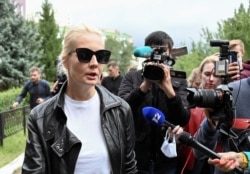 Yulia Navalnaya, wife of Russian opposition leader Alexei Navalny, speaks with the media outside a hospital, where Alexei receives medical treatment in Omsk, Russia, Aug. 21, 2020.
