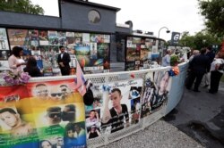 People gather at the Pulse nightclub before a news conference to introduce legislation that would designate the site as a national memorial, June 10, 2019, in Orlando, Fla.
