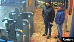 FILE - Alexander Petrov and Ruslan Boshirov, accused of trying to kill former Russian intelligence officer Sergei Skripal and his daughter in Salisbury, England, are seen on CCTV at Salisbury Station, March 3, 2018, in an image handed out by London police, Sept. 5, 2018.