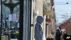People stand outside a small store in Camden, New Jersey, which has the highest poverty rate in the nation, and has among the nation's highest unemployment, school dropout and homeless rates, February 10, 2011
