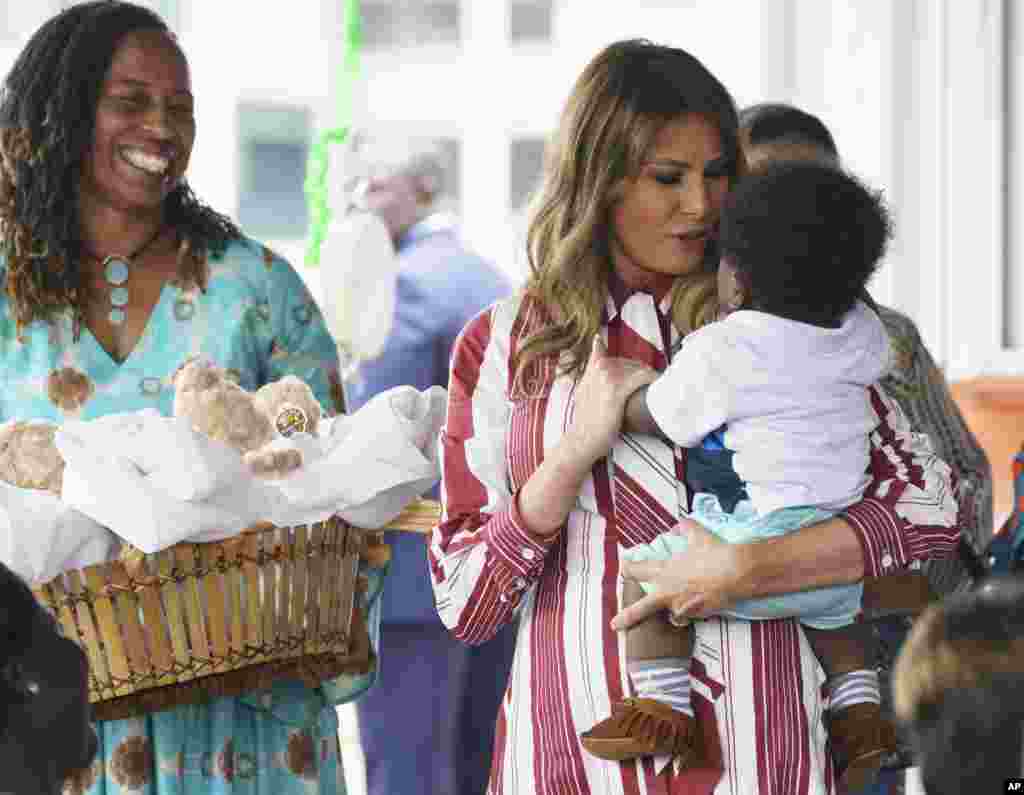 First lady Melania Trump holds a baby as she visits Greater Accra Regional Hospital in Accra, Ghana, Oct. 2, 2018.