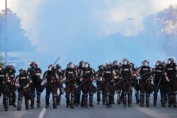 State patrol officers clear an area after a curfew went into effect in Minneapolis, Minnesota, May 30, 2020.