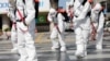 South Korean soldiers wearing protective gear sanitize a street in front of the city hall after the rapid rise in confirmed cases of the novel coronavirus disease of (COVID-19) in Daegu, southeast of the capital Seoul, South Korea, March 2, 2020. 