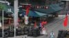 Traffic passes a barricade in Bangkok, Thailand, 13 May 2010