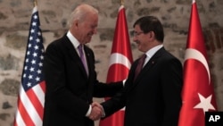 U.S. Vice President Joe Biden, left, and Turkish Prime Minister Ahmet Davutoglu shake hands before a meeting in Istanbul, Turkey, Nov. 21, 2014. 