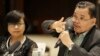 Moro Islamic Liberation Front (MILF) chief peace negotiator Mohagher Iqbal, right, with Miriam Coronel-Ferrer, chief negotiator for the government, gestures during a forum with foreign correspondents at suburban Mandaluyong city, east of Manila, April 7, 2015.