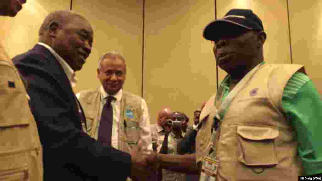 Former Nigerian President Olusegun Obasanj, right, greets former Zambian President Rupiah Banda after a news conference held by Commonwealth Observers team in Kampala, Feb. 20, 2016. Obasanjo heads Commonwealth Observers and Banda heads the Electoral Inst