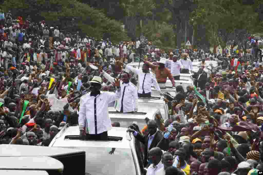 Raila Odinga, Kalonzo Musyoka and Moses Wetangula wave during a rally at Uhuru Park in Nairobi, July 7, 2014.