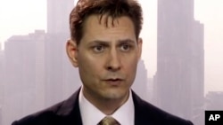 FILE -Image made from a video on March 28, 2018 shows Michael Kovrig, an adviser with the International Crisis Group, a Brussels-based non-governmental organization, speaking during an interview in Hong Kong. 