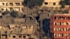 Houses lie in ruin in Khiam, a town near the Lebanese-Israeli border that was hit by Israeli air strikes on June 21, 2024, as seen from the Lebanese town of Marjayoun on June 22. 