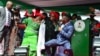 Patience Jonathan (C), wife of Nigeria's President Goodluck Jonathan, dances with supporters during a rally by Jonathan's ruling People's Democratic Party, March 14, 2015. 