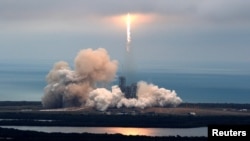 FILE - A SpaceX Falcon 9 rocket disappears into clouds after it lifted off on a supply mission to the International Space Station from historic launch pad 39A at the Kennedy Space Center in Cape Canaveral, Florida, Feb. 19, 2017.
