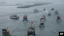 FILE - Several dozen fishing boats flying Taiwanese national flags set out from the Suao harbor, northeastern Taiwan, Sept. 24, 2012.