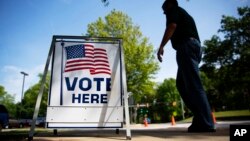 FILE - A voter leaves a polling site after casting a ballot in a special election in Marietta, Ga.