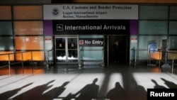 FILE - An international traveler arrives after U.S. President Donald Trump's executive order travel ban at Logan Airport in Boston, Massachusetts, Jan. 30, 2017. 