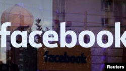 The logo of Facebook is pictured on a window at new Facebook Innovation Hub during a media tour in Berlin, Germany, Feb. 24, 2016. 
