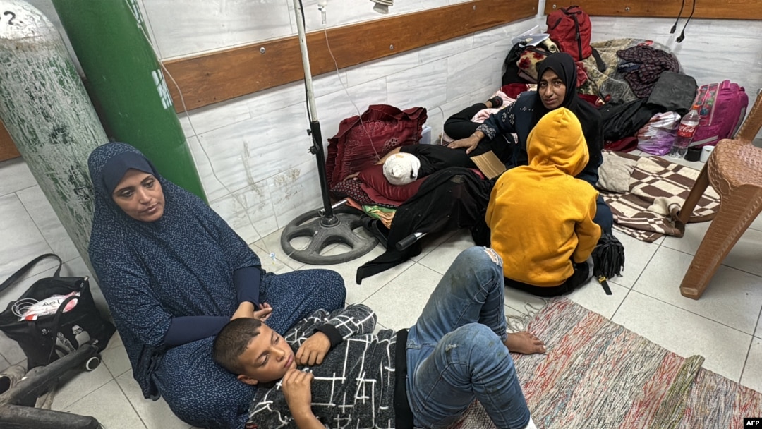 FILE - Women and children wait for medical attention as they sit on the floor of the trauma ward in the Kamal Adwan Hospital in Beit Lahia the northern Gaza Strip, Oct. 24, 2024.