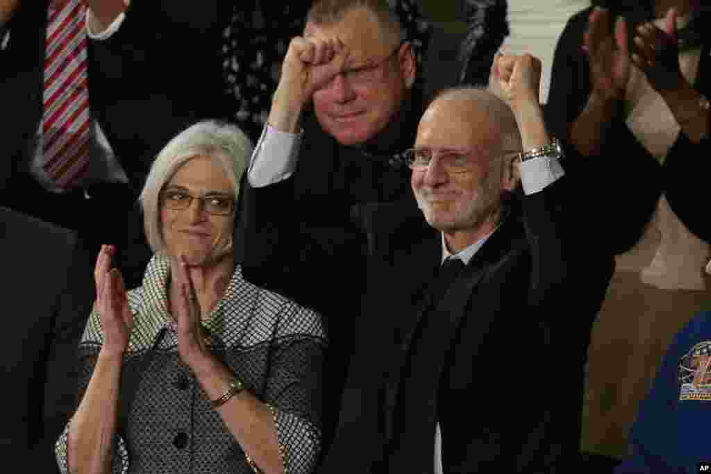 Alan Gross, who was recently released from prison in Cuba, acknowledges applause during President Barack Obama's State of the Union address before a joint session of Congress, Jan. 20, 2015.