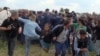 Hungary: Parliament Bans Camerawoman Who Kicked Migrants