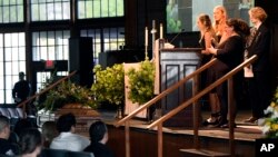 Iris Howell, sister of Riley Howell, speaks during his memorial service as sister Juliet and brother, Teddy listen in Lake Junaluska, N.C., May 5, 2019.