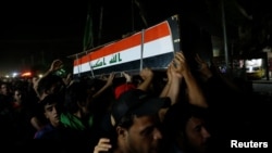Men carry the coffin of a demonstrator who was killed during anti-government protests, in Baghdad, Iraq October 4, 2019. Picture taken October 4, 2019.
