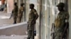 FILE - Ugandan soldiers stand along a street in Kampala, Uganda, Feb. 20, 2016. Ugandan President Yoweri Museveni extended his 30-year rule earlier this year by winning an election critics say lacked transparency and his main opponent Kizza Besiyge denoun