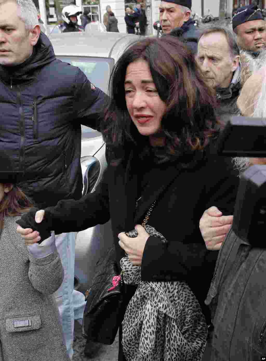 Elsa Wolinski, daughter of French cartoonist Georges Wolinski, arrives at her father's funeral at the Pere Lachaise cemetery, in Paris, Jan. 15, 2015.