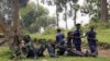 M23 rebel fighters guard the venue of a news conference by political leader Jean-Marie Runiga in north Kivu province near the border with Uganda, July 21, 2012.