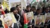 Palestinians shout slogans to support Palestinian President Mahmoud Abbas ahead of his meeting with U.S. President Barack Obama Monday, Tubas, West Bank, March 16, 2014.