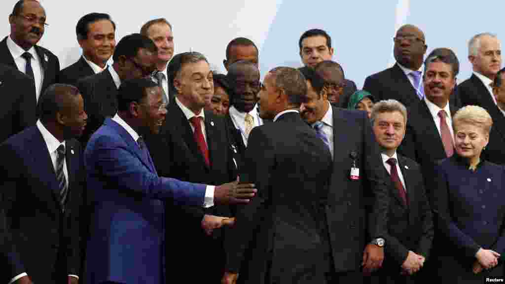 U.S President Barack Obama (C) arrives for a family photo during the opening day of the World Climate Change Conference 2015 (COP21) at Le Bourget, near Paris, France, November 30, 2015.