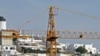 A crane is seen over an abandoned tourist resort construction in Gale on the southern Portuguese province of Algarve, March 6, 2012.