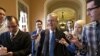 Senate Minority Leader Mitch McConnell of Kentucky, center, arrives at his office in the Capitol as he and Senate Majority Leader Harry Reid of Neveda, try to negotiate a legislative solution to avoid the so-called "fiscal cliff", Sunday, December 12, 2012.