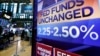 A screen on the floor of the New York Stock Exchange shows the rate decision of the Federal Reserve, March 20, 2019. 