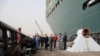 Oussama Rabieh, chairman of the Suez Canal Authority, monitors the situation near the stranded container ship Ever Given after it ran aground, in Suez Canal, Egypt, March 25, 2021. 