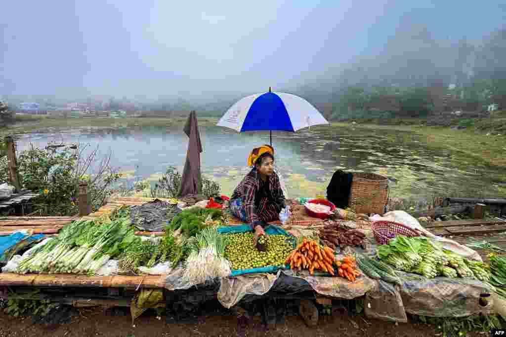 A vendor prepares her stall as she waits for customer at a street market in Taunggyi, Myanmar's northeast Shan Sate.