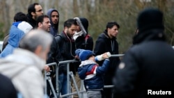 Migrants wait for their registration in front of the Federal Office for Migration and Refugees at Berlin's Spandau district, Germany, Jan. 29, 2016.