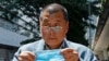 FILE - Hong Kong media tycoon Jimmy Lai enters a court in Hong Kong on May 5, 2020. A key prosecution witness in Lai's trial on collusion and sedition charges may have been mistreated in custody, U.N. officials say, drawing into question whether his testimony was coerced.