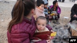 Residents gather outdoors the morning after an earthquake in Dahejia, Jishishan County, in northwest China’s Gansu province on Dec.19, 2023.