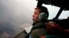 Co-Pilot, Flying Officer Marc Smith, turns his Royal Australian Air Force (RAAF) AP-3C Orion aircraft at low level in bad weather whilst searching for the missing Malaysian Airlines Flight MH370 over the southern Indian Ocean, March 24, 2014.