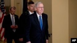 FILE - Senate Majority Leader Mitch McConnell walks to the Senate Chamber on Capitol Hill in Washington, March 23, 2020.