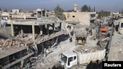Residents inspect damage at a site hit by one of three explosive trucks, in the YPG-controlled town of Tel Tamer, Syria December 11, 2015. ( REUTERS/Rodi Said)