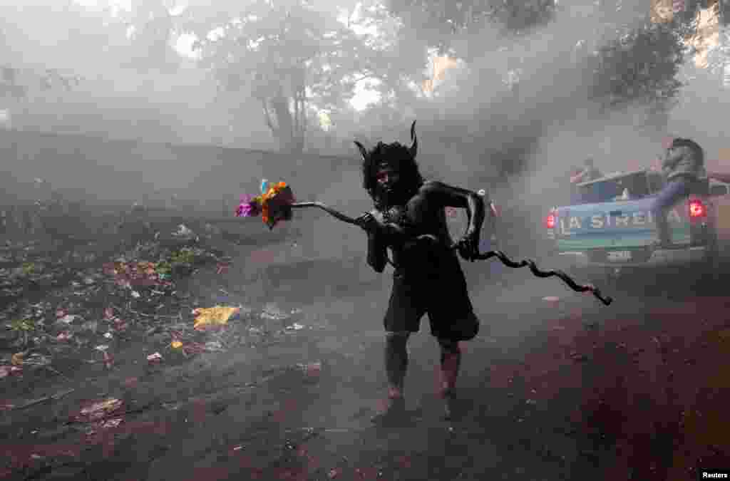 A devotee covered in oil takes part in festivities honoring the capital's patron saint, Santo Domingo de Guzman, in Managua, Nicaragua, Aug. 1, 2017.