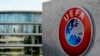 A man walks inside the headquarters of European football body UEFA in Nyon on April 6, 2016. Swiss police raided the UEFA headquarters on April 6 following the latest revelations of a web of Panama-based offshore financial dealings by the rich and famous.