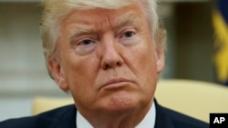 President Donald Trump listens during a meeting with Ukrainian President Petro Poroshenko in the Oval Office of the White House, June 20, 2017, in Washington.