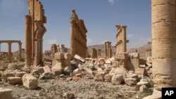 This photo released pm March 28, 2016, by the Syrian official news agency SANA, shows some damage at the ancient ruins of Palmyra, central Syria. 