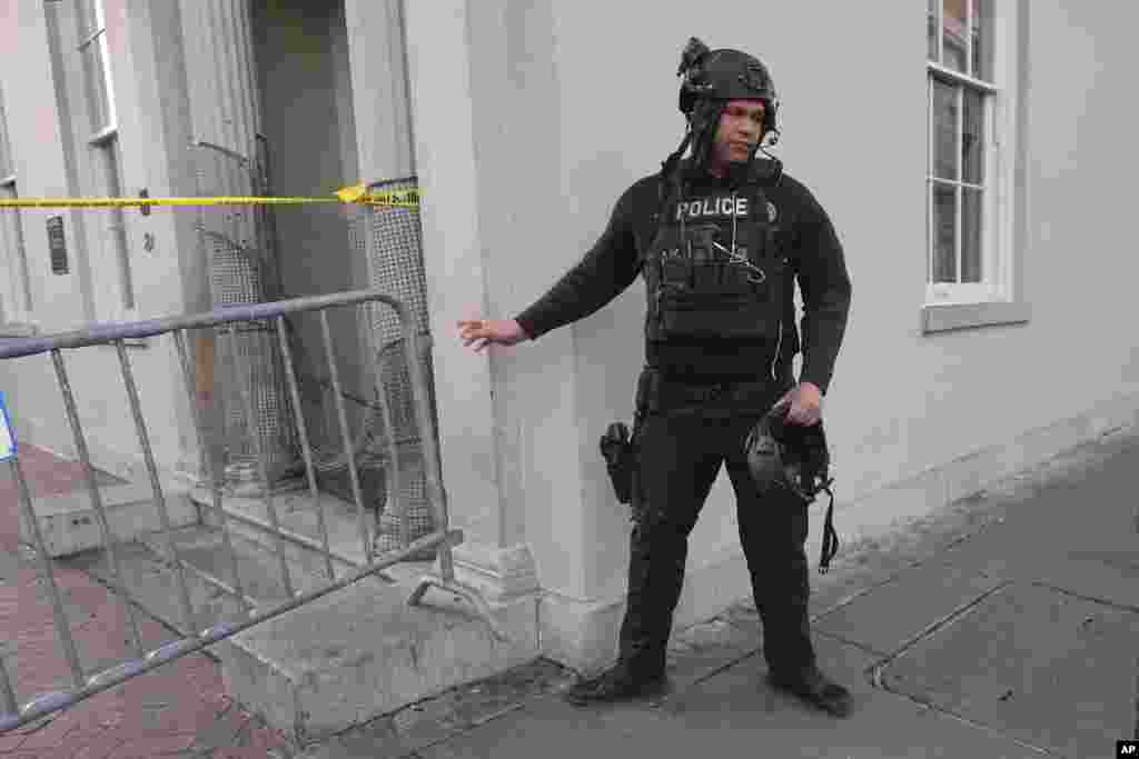 A member of the emergency services attends the scene after a vehicle drove into a crowd on New Orleans' Canal and Bourbon Street, Jan. 1, 2025.
